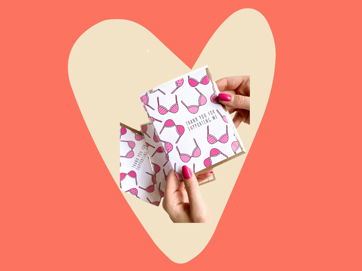 A pair of hands hold a greeting card featuring pink bras and that reads, "Thank you for supporting me."