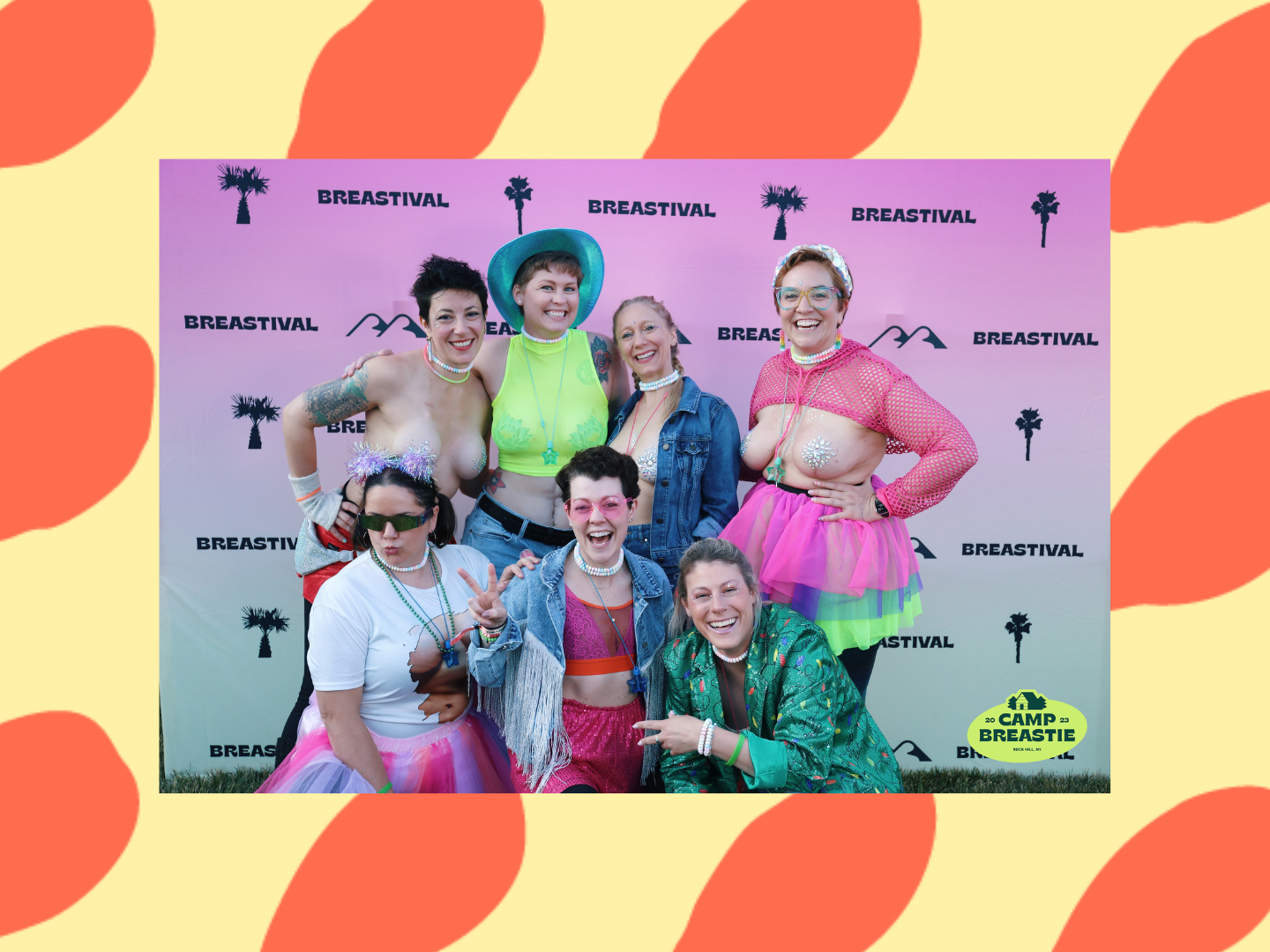 Falon, in a neon green mesh tanktop that allows you to see her tattooed breasts, poses with cabinmates at Camp Breastie