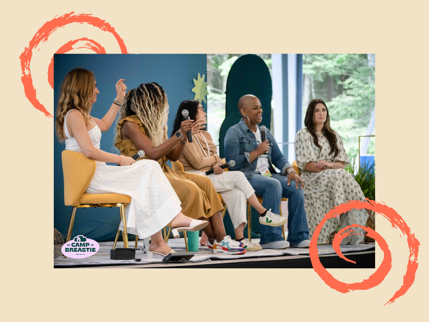 Five panelists sit on stage, snapping and smiling as Sheila, a stage 4 Breastie speaks into a microphone.