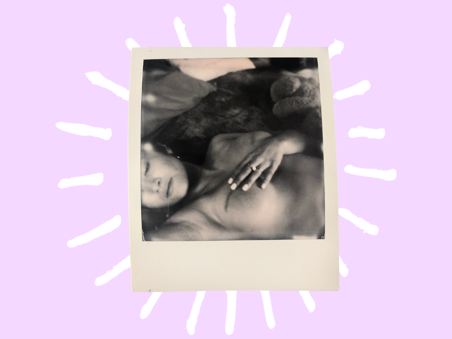 A black and white polaroid of Bianca, showing off her mastectomy scars. 